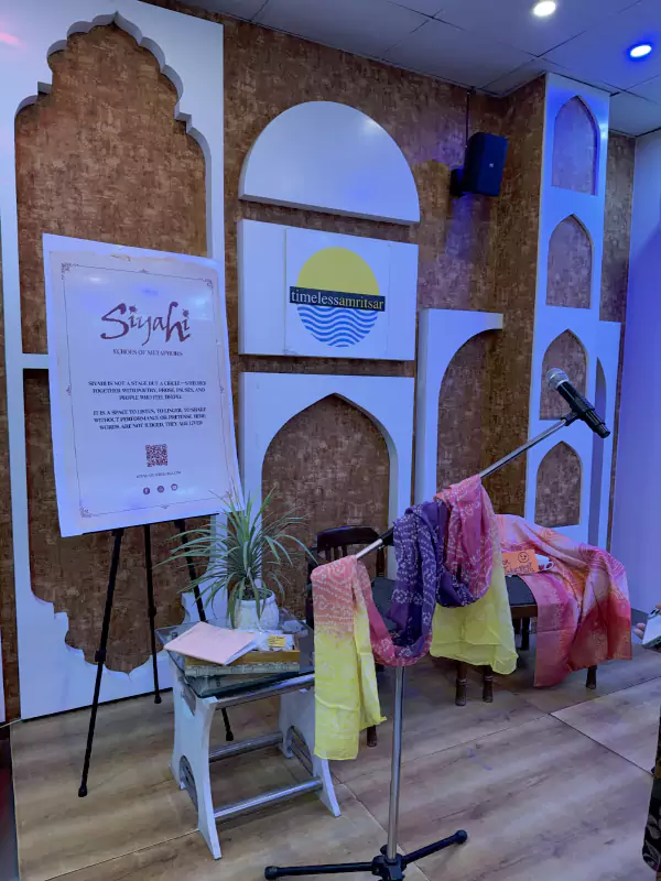 Aunty Please event stage setup with microphone and colorful dupattas symbolizing aunties at Siyahi literary gathering in Amritsar