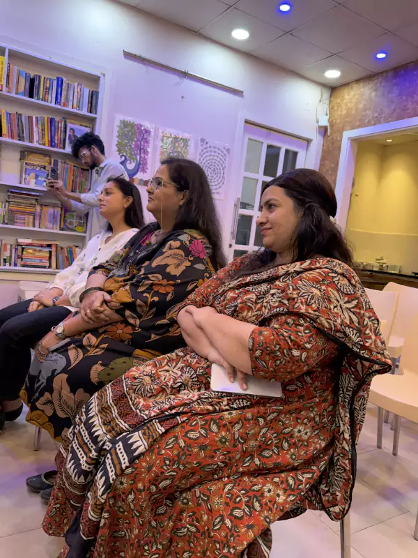 Women seated and attentively watching performances at Siyahi’s Aunty Please event in Amritsar
