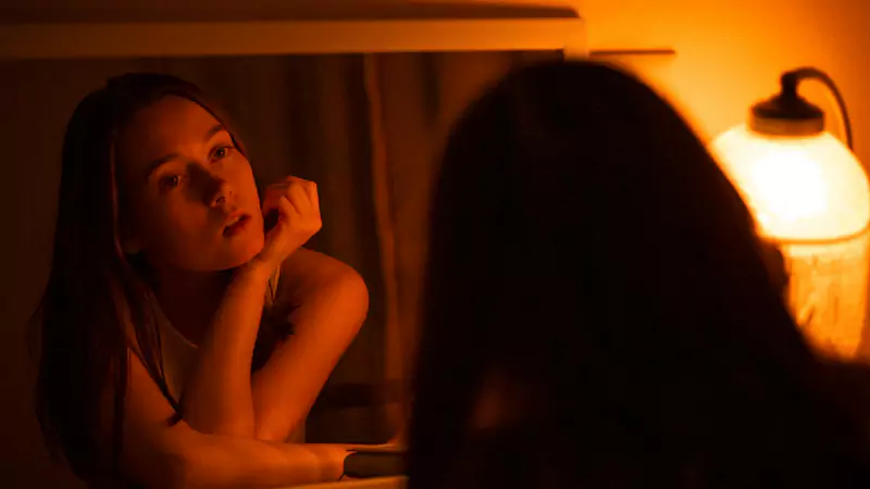 A girl standing in front of a mirror, seeing different versions of herself — a visual for the poem “A Misfit, Yet Me” on Siyahi Blog, symbolizing individuality, contrasts, and self-acceptance.